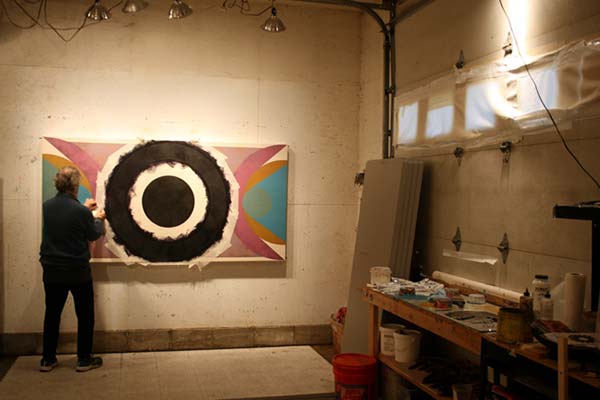 Sandy Sokoloff works on a painting in his studio